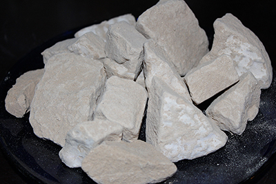 Caliche clay chalk chunks. Caliche is a desert clay dirt that is hard when dry, and a powdery chalk