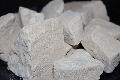 Caliche clay chalk chunks. Caliche is a desert clay dirt that is hard when dry, and a powdery chalk