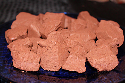 This edible reddish brown clay in mined from a mountain wall.