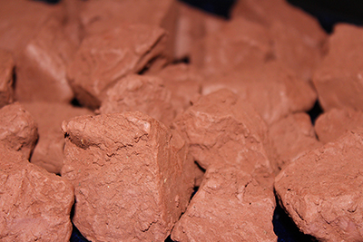 This edible reddish brown clay in mined from a mountain wall.