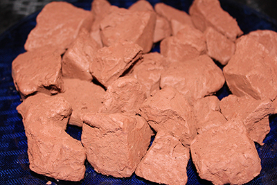 This edible reddish brown clay in mined from a mountain wall.