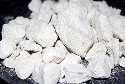 Gritty white clay that is edible and has giant pieces.