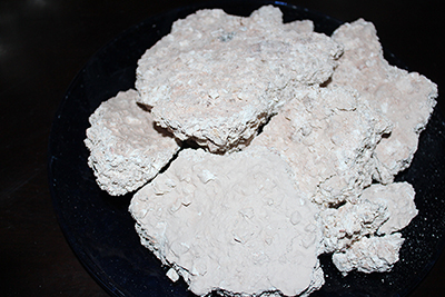 Crumbly white clay that has a rainy taste of kaolin mine wall washes from the rains.