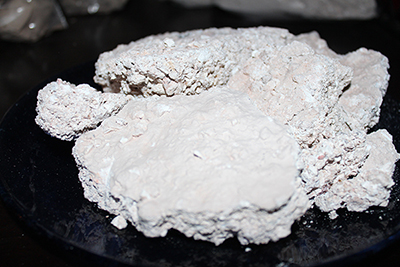 Crumbly white clay that has a rainy taste of kaolin mine wall washes from the rains.